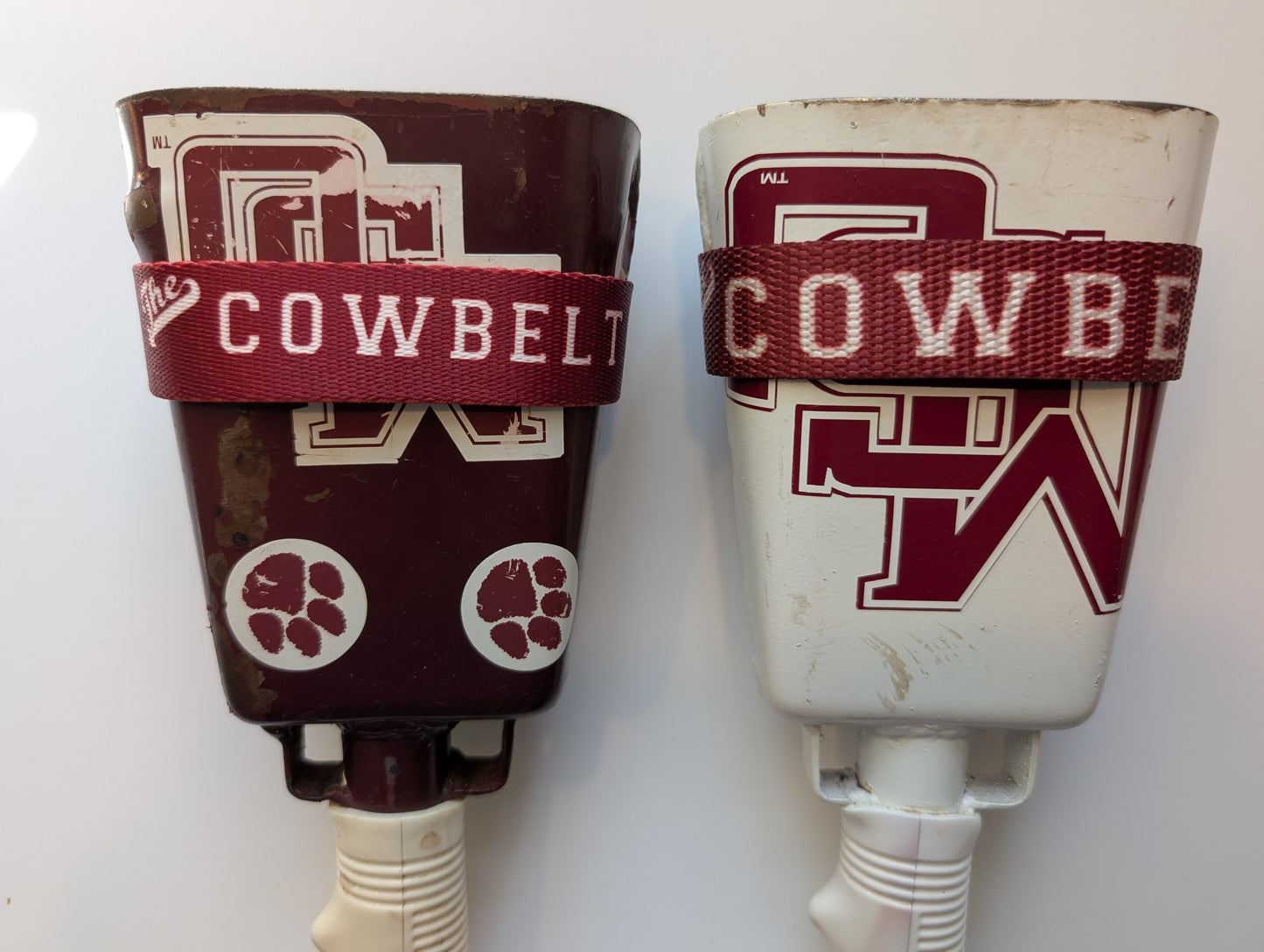 Old version compared to the new version Cowbelt strap while holstering a cowbell
